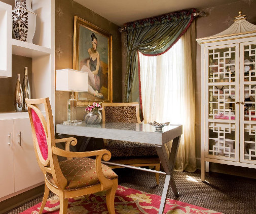 An eclectic home office with an ornate cabinet and chair.