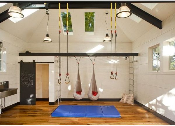 A garage conversion into a room featuring a gym and a hanging hammock.