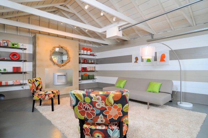 A living room with a couch and chairs in a garage conversion.