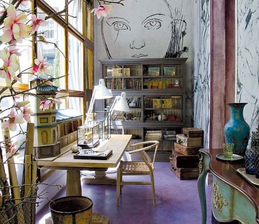 A vibrant and eclectic home office adorned with a captivating mural on the wall.