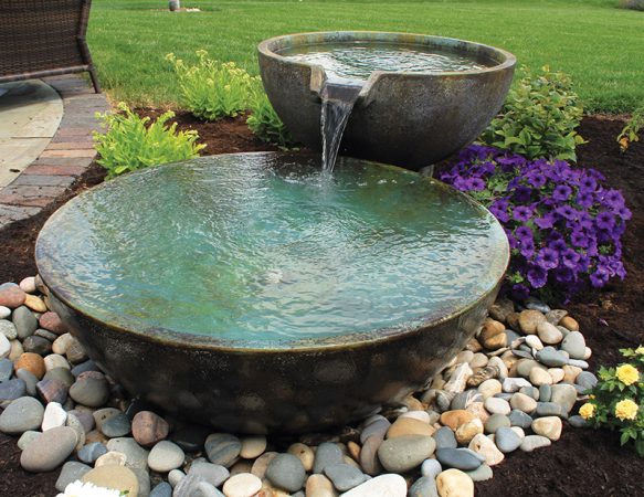 A small fountain enhances backyard relaxation