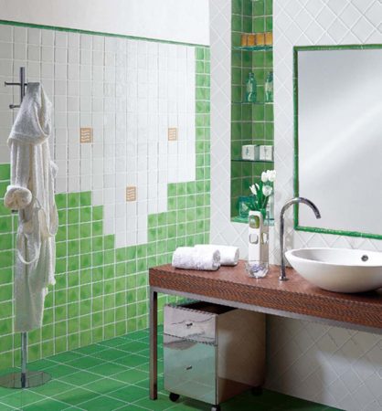 A beautiful green and white bathroom with a sink and mirror featuring stunning tile ideas.