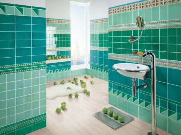 A beautiful bathroom with green and blue tiles.