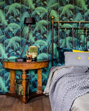 Tropical wallpaper enhances a bedroom