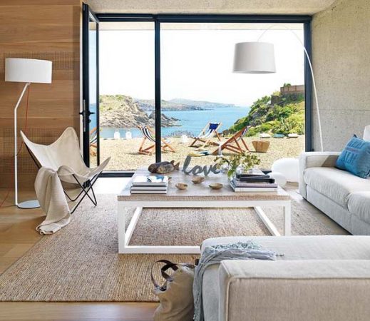 A light-filled living room with a view of the ocean.
