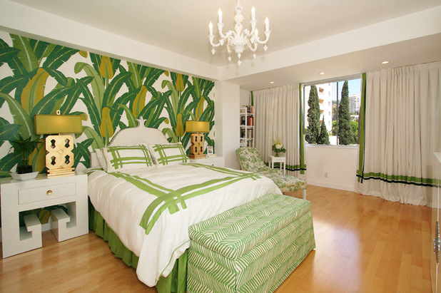 A tropics-inspired bedroom with green and white wallpaper.