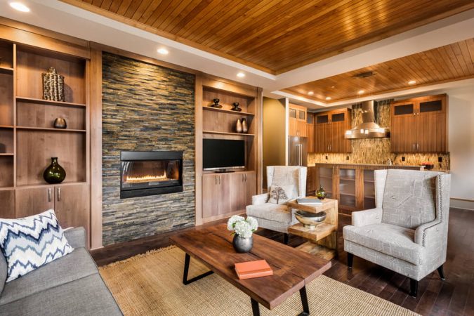 Stone fireplace and wood clad ceiling enhance this space 