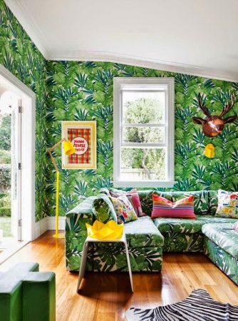 A living room with tropical wallpaper and zebra print furniture inspired by the tropics.