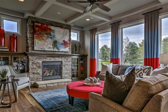 A statement living room with a fireplace and red accents.