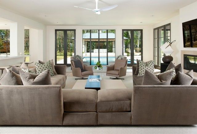 A spacious family room with cozy couches and a fireplace.