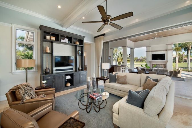 A family room with couches and a ceiling fan.