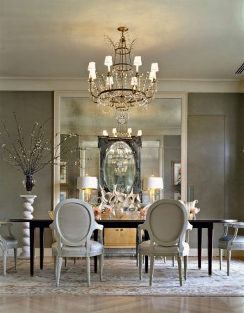 A dining room with a gray chandelier.