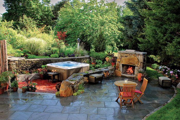 A backyard with patio furniture and hot tub patio ideas.