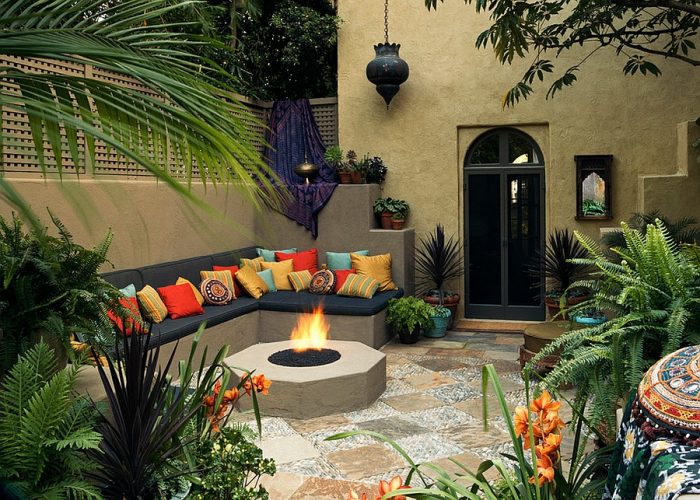 Patio ideas featuring a fire pit and abundant plants.