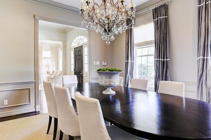 A formal dining room with a gray chandelier.