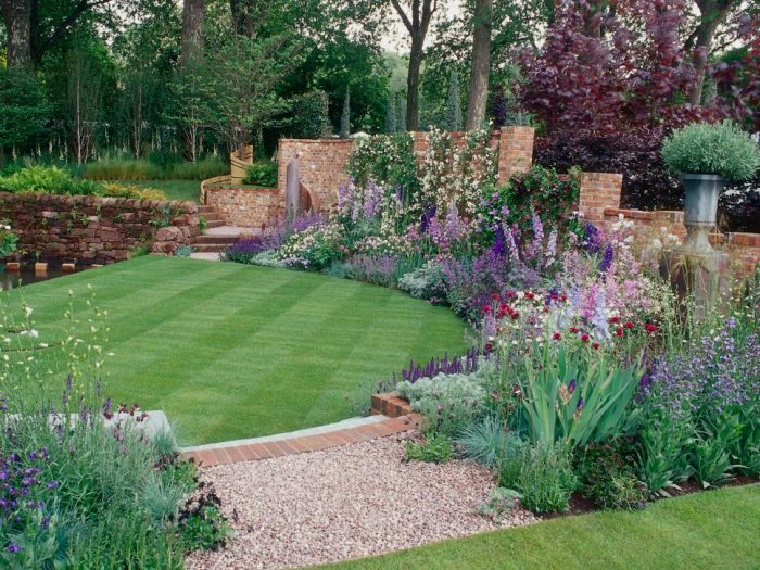 A garden with a stone path and flowers, featuring patio ideas.