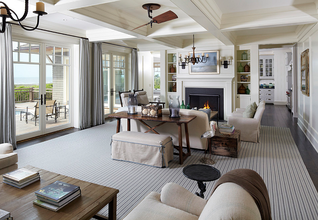 A Cape Cod living room with white furniture and a fireplace.