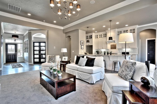 A living room with gray furniture and a chandelier.