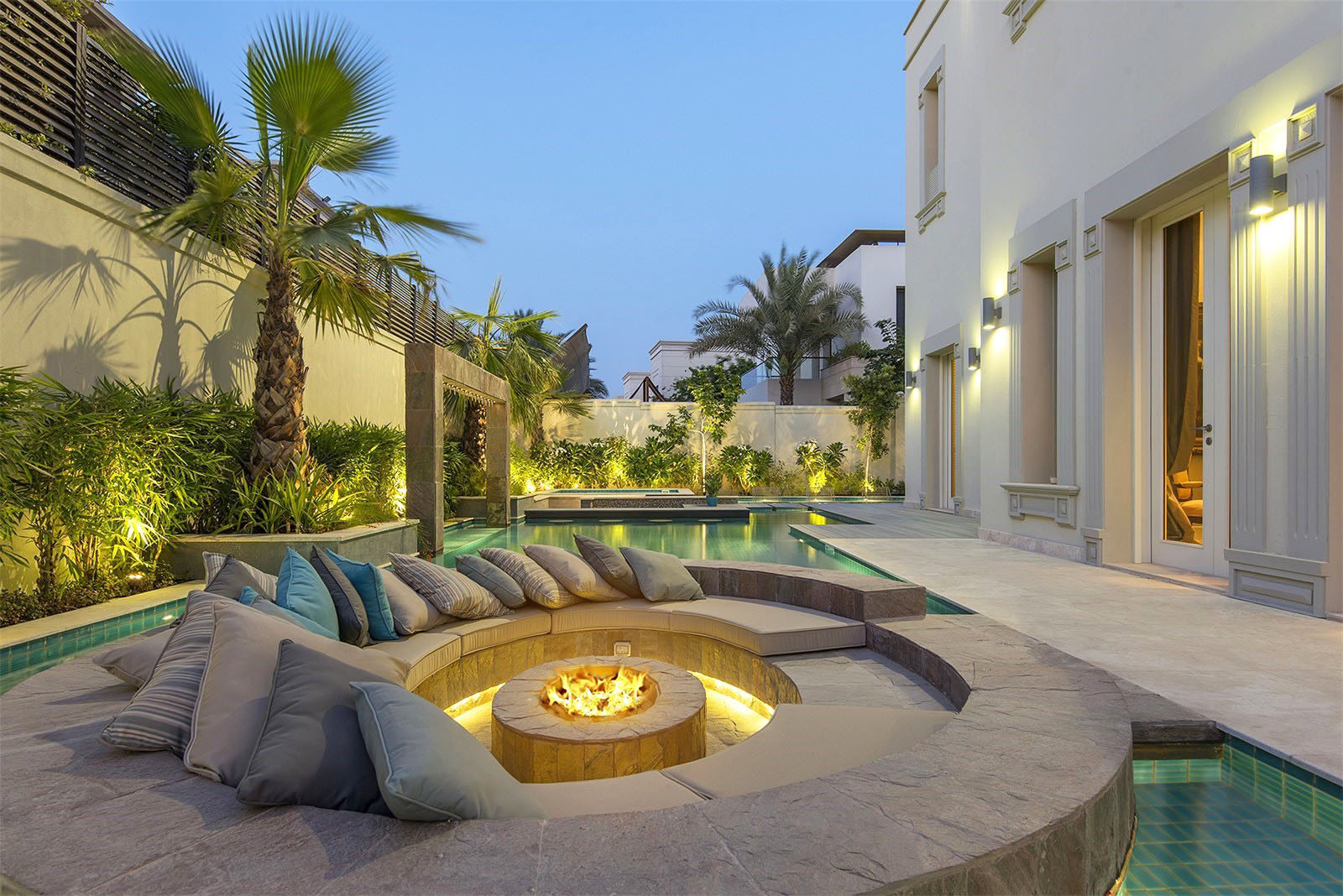 Unique patio idea featuring a fire pit in the middle of a pool.