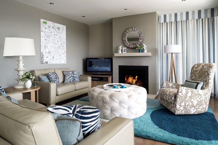 A gray and cream living room with couches and a fireplace.