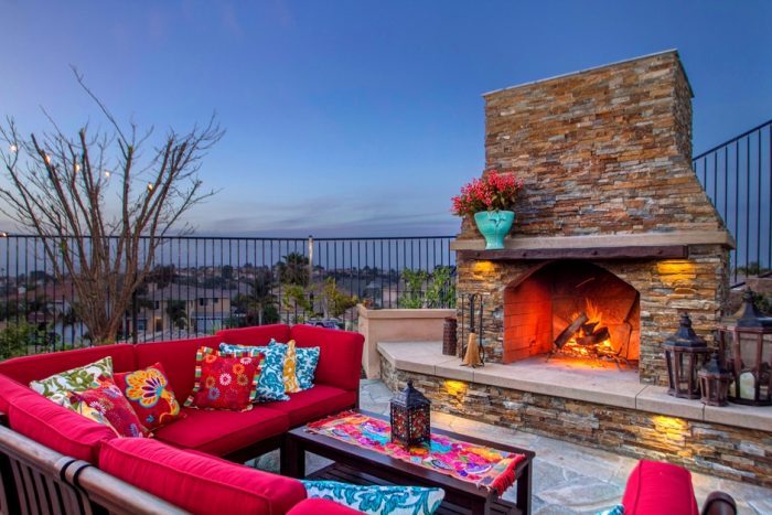A fire pit and red furniture for patio ideas.