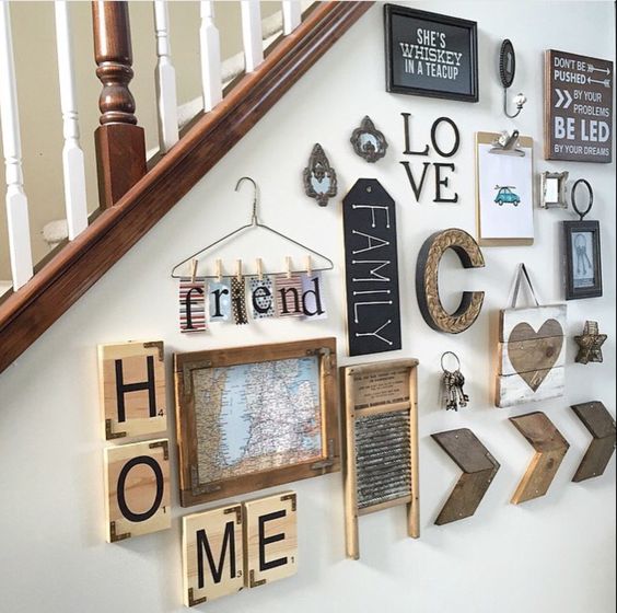 A stairway with a lot of signs and pictures on it, located in a living room.