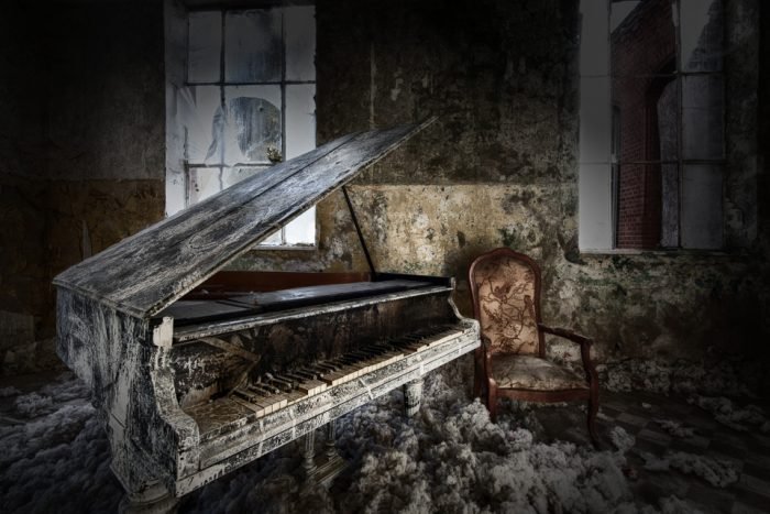 An abandoned piano in a room in Germany.