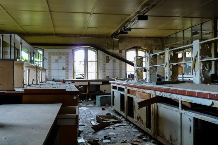 An abandoned laboratory in Germany with broken windows and counters.