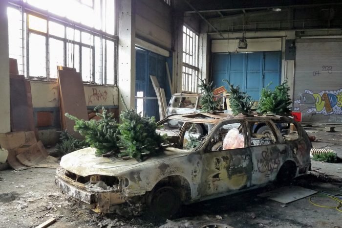 A car with Christmas trees in an abandoned building in Germany.