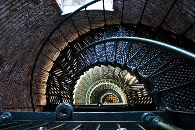 A spiral staircase in a brick building.