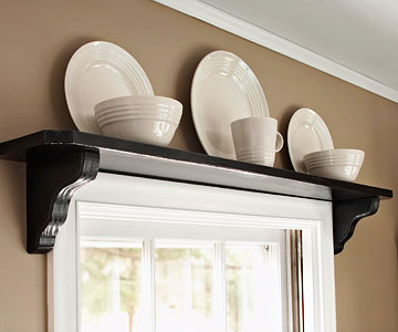 Space Saving window shelf with plates and bowls.