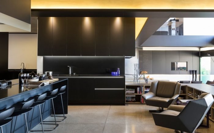 A modern kitchen with black cabinets at Kloff Road House.