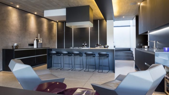 A modern kitchen with a black and grey color scheme in the Kloff Road House.
