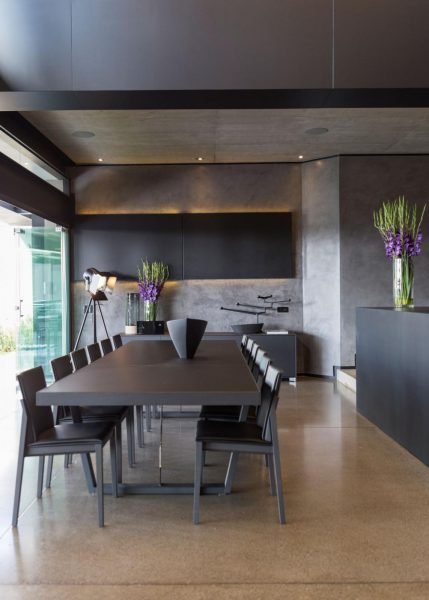A Kloff Road House with a modern black dining room.
