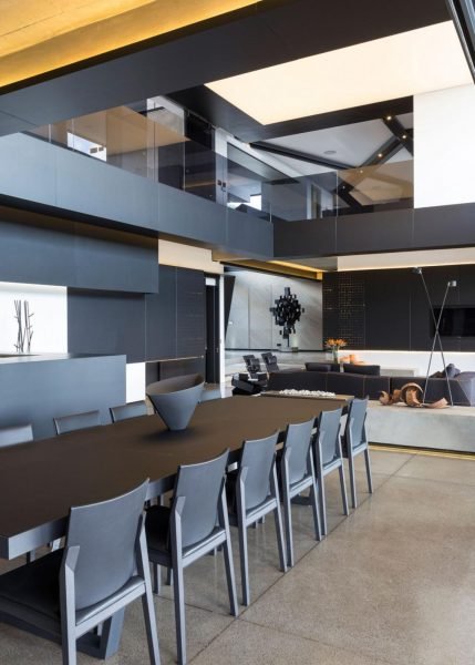 Kloff Road House: A modern dining room with a black table and chairs.