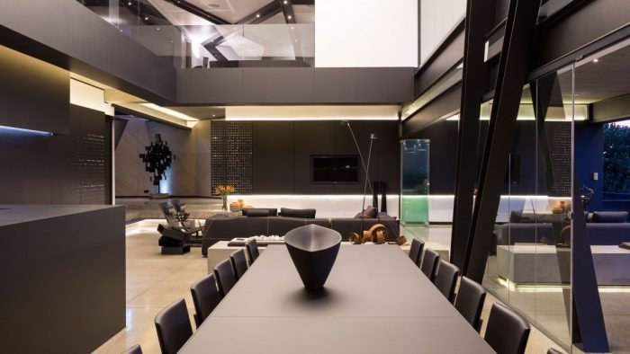 A modern dining room with a black table and chairs at the Kloff Road House.