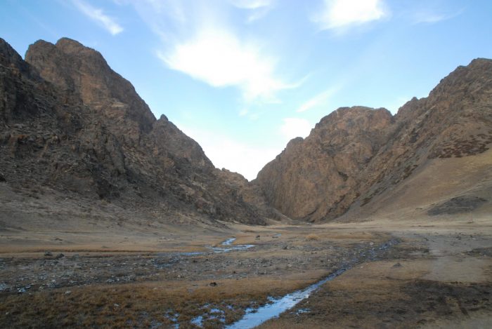 Gobi desert with ice canyon, stream, and blue sky