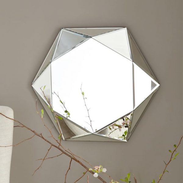 A faceted mirror hanging on a wall.