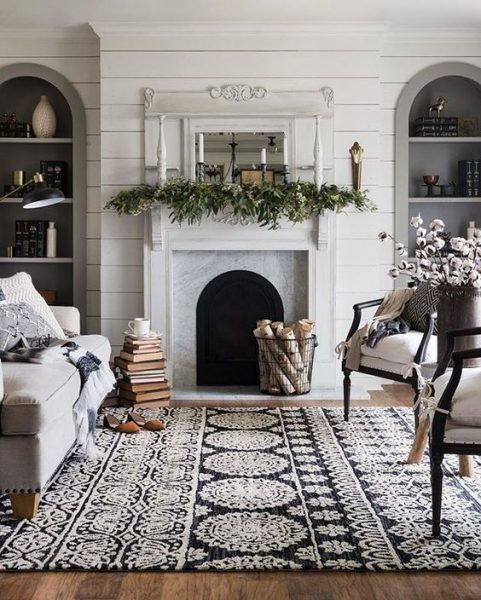 A monochrome living room with a fireplace.