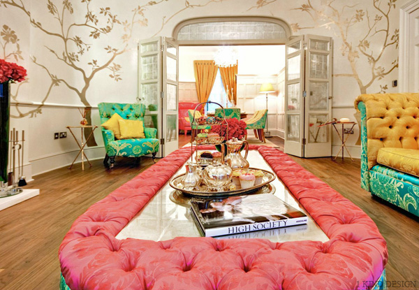 A living room with bright colored couches and chairs.