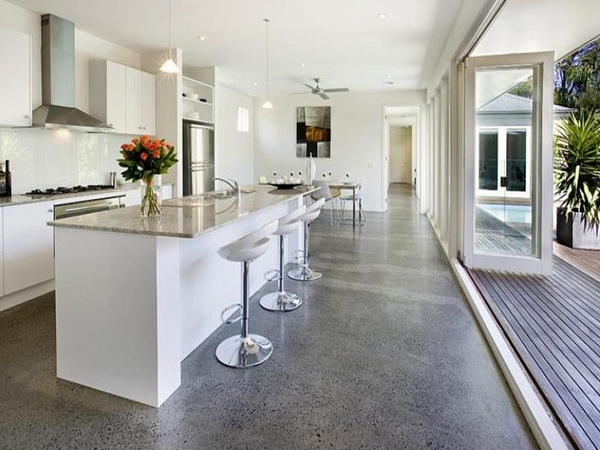 A modern kitchen with a large island and [flooring].