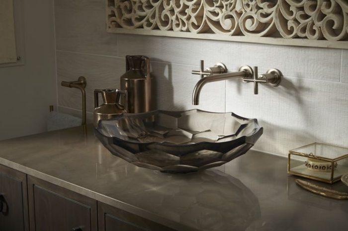 A bathroom sink with an ornate faceted design.