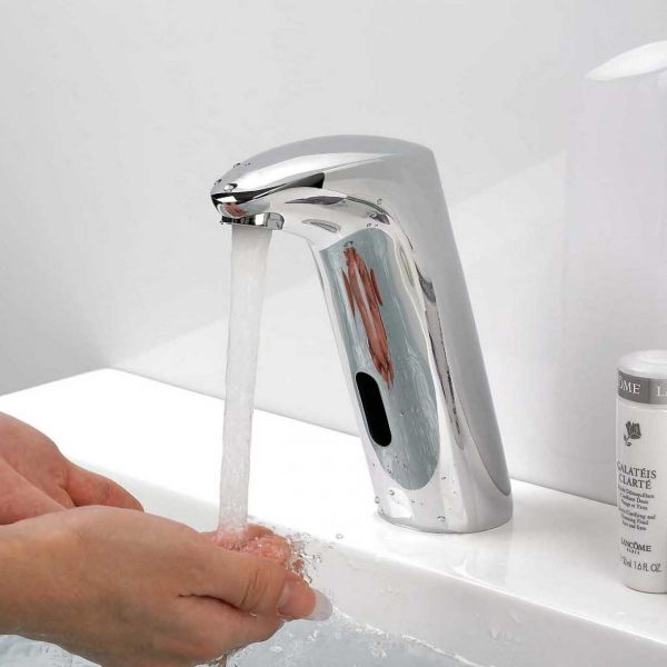 A person is washing their hands with a faucet to conserve water.
