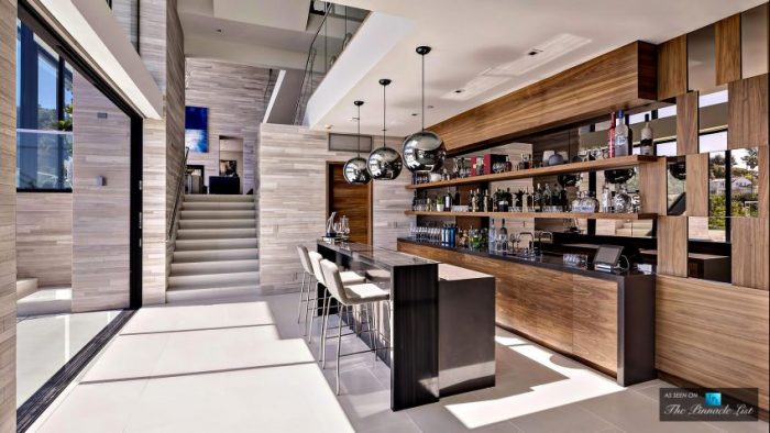 A stunning residence with a bar and stairs.