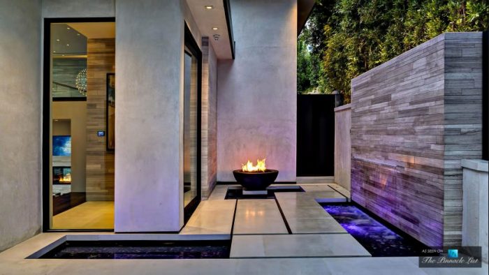A stunning residence with a fire pit in the front yard.