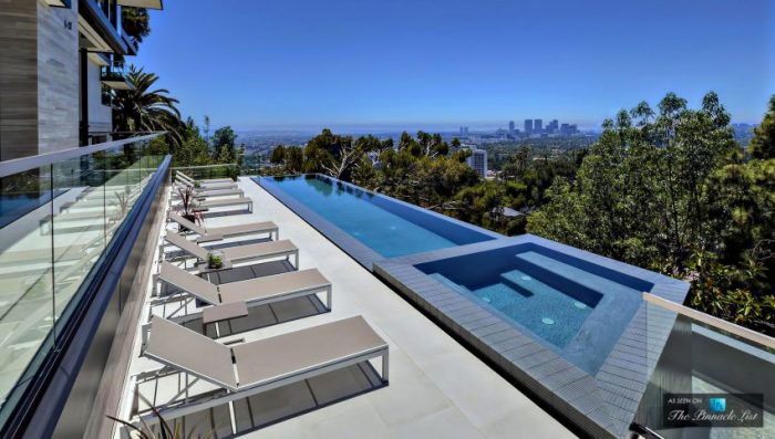A stunning residence with a swimming pool and city view.
