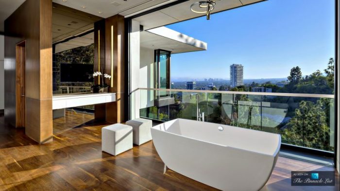 A stunning residence with a bathtub and a view of the city.