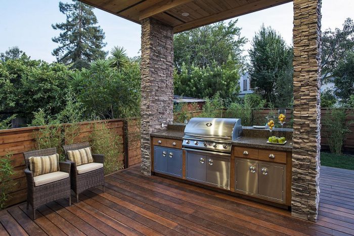 A modern outdoor kitchen on a wooden deck.