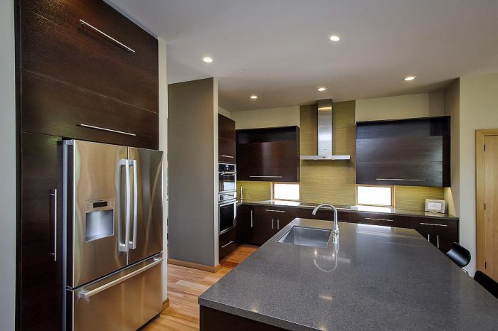 A modern kitchen in a prefabricated home with stainless steel appliances.