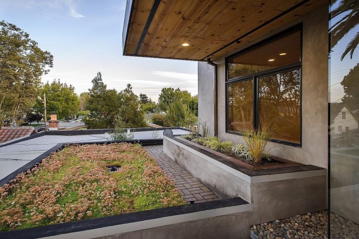 A modern prefabricated home with a green roof.